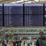A man studying the departures board at Hamburg Airport.