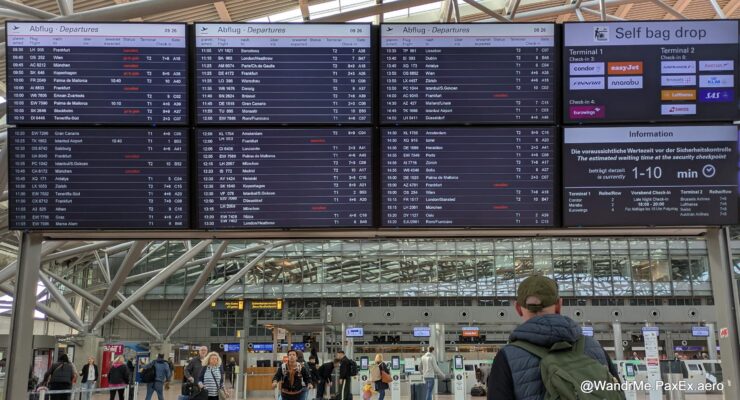 A man studying the departures board at Hamburg Airport.