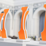 Trophies backed in bright orange on a display table